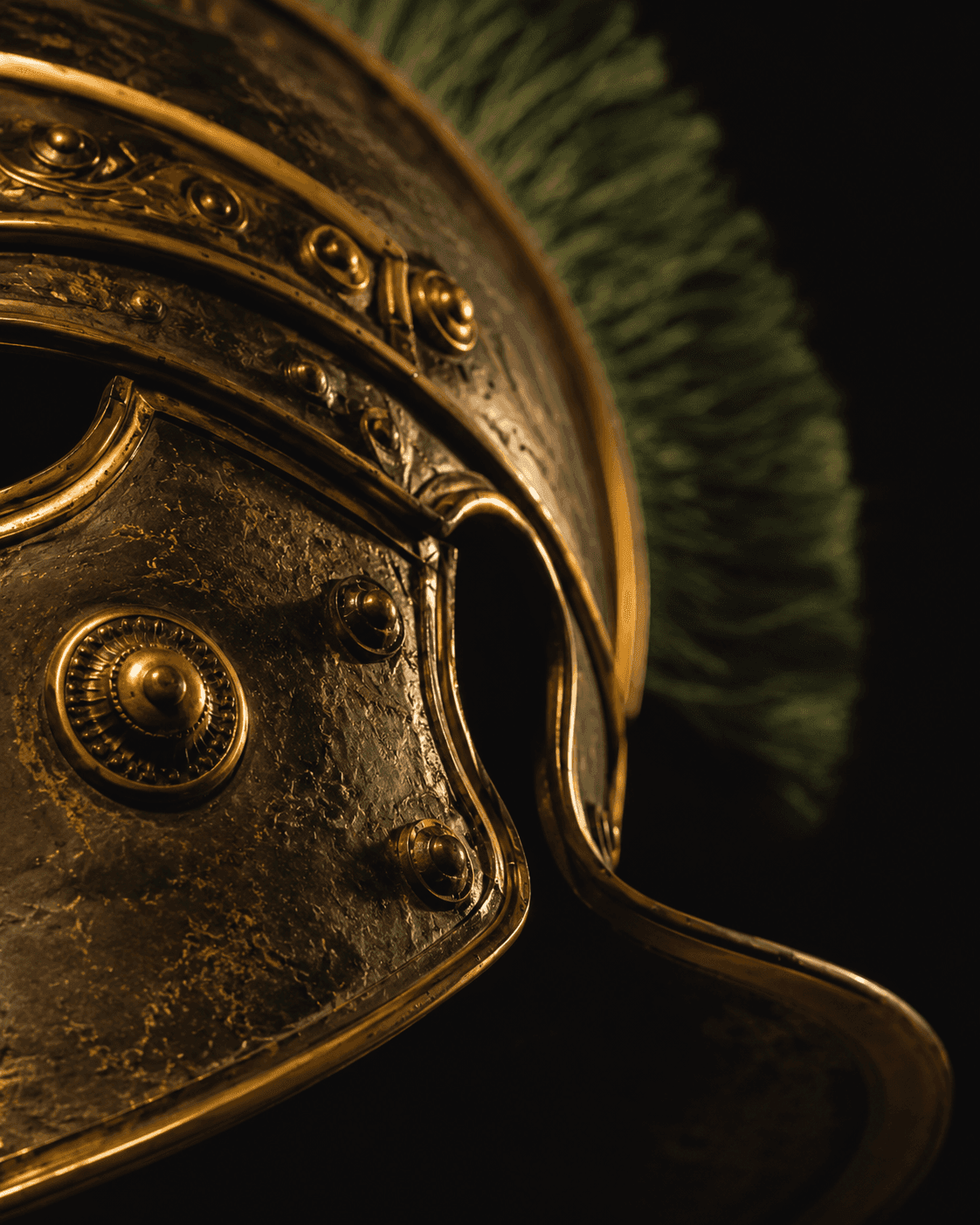 Close-up of a Roman helmet with gold detailing and a green plume against a dark background — Fortaleo digital architecture